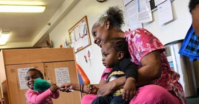 Childcare worker Debbie James-Dean sits with children at a Kids Are Us Learning Center in Southeast Washington, D.C., on March 24, 2017. In New Mexico, families earning up to $111,000 per year are now eligible for a pilot program providing free child care. (Photo: Toni L. Sandys/The Washington Post via Getty Images)