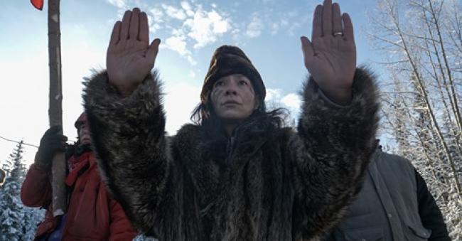 Sabina Dennis holds her hands up as RCMP tactical teams approach the Gidimt'en checkpoint on Wet'suwet'en territory on Jan. 7, 2019. Photo by Michael Toledano