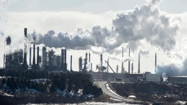 An oil refinery is seen in this June 2019 file photo. A new campaign is calling on people and governments in B.C. to back a plan to take oil companies to court for their role in climate change. (Andrew Vaughan/Canadian Press)