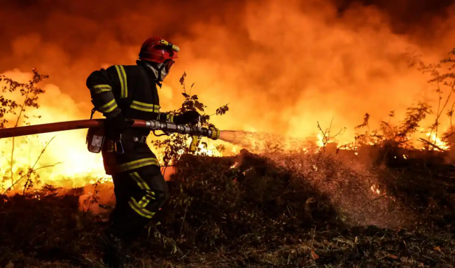 ‘The dangerous heat England is suffering at the moment is already becoming normal in southern Europe.’ A firefighter tackles a wild fire in Gironde, France, 17 July 2022. Photograph: Thibaud Moritz/AFP/Getty Images