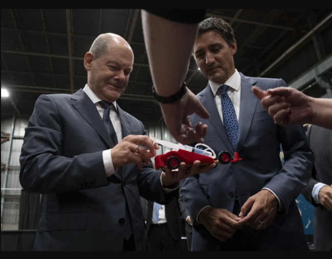Canadian Prime Minister Justin Trudeau and German Chancellor Olaf Scholz examine a hydrogen powered toy car as they tour a trade show, Tuesday, August 23, 2022 in Stephenville, Newfoundland and Labrador. THE CANADIAN PRESS/Adrian Wyld