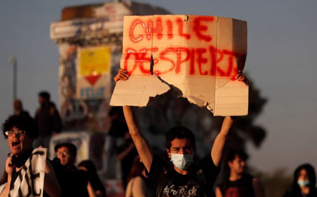 A Santiago protester holds up a placard reading “Wake Up Chile” on September 5, the day after Chilean voters overwhelmingly rejected the country's new Constitution in a referendum vote. (Photo by Javier Torres / AFP)
