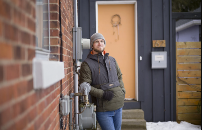 Drew Tozer in front of the home he decarbonized, offering an alternative to natural gas hookups. Photo by Ian Willms/Canada's National Observer