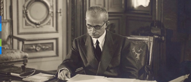 Photo: Luigi Einaudi, then president of Italy, sits at his desk in 1948. Einaudi supported Mussolini’s economic agenda. Wikimedia Commons.