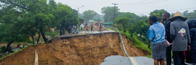 People look at a damaged road in Blantyre, Malawi on March 14, 2023.(Photo: Joseph Mizere/Xinhua via Getty Images)
