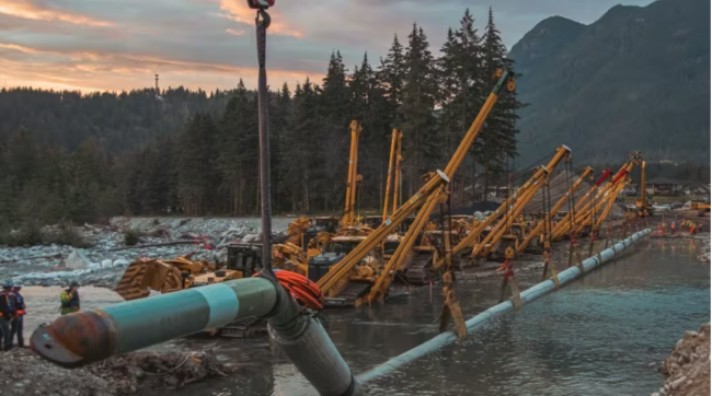 A replacement pipeline segment is lowered into the Coquihalla River by Trans Mountain near Hope, B.C., on Aug. 9, 2022.  CBC News 2023