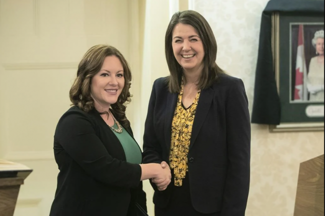 Environment Minister Rebecca Schulz says negotiations between water licence holders in three southern Alberta river basins will open this week. Schulz shakes hands with Premier Danielle Smith in Edmonton on Oct. 24, 2022. THE CANADIAN PRESS/Jason Franson