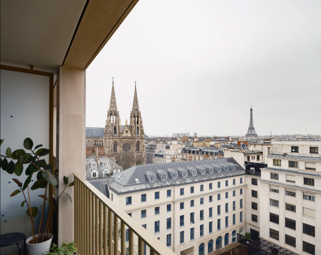 Even on a gray winter’s day, the Eiffel Tower stands out from the balcony of the new Îlot Saint-Germain public housing development in the Seventh arrondissement. The apartment’s resident, Marine Vallery-Radot, is among hundreds of thousands of Parisians living in public housing.Credit...Alex Cretey-Systermans for The New York Times