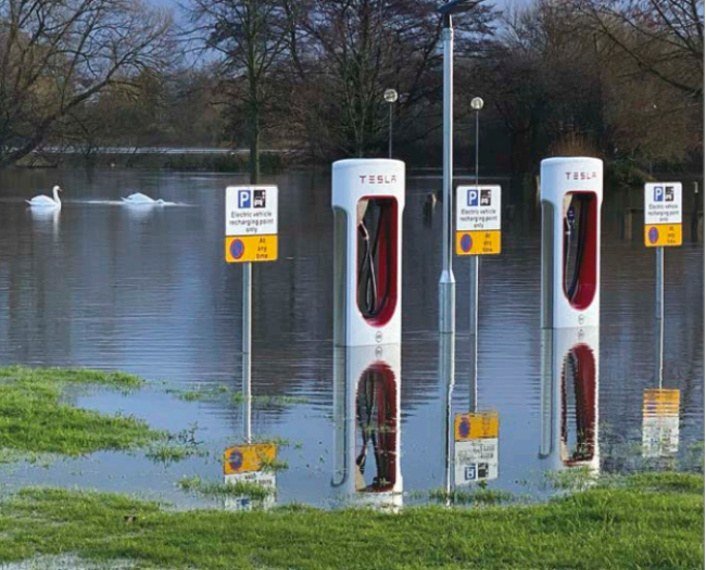 Tesla car charging points at Sindlesham, UK, underwater owing to heavy winter rain (photo: Phil Creighton, Editor of The Wokingham Paper; see https://is.gd/teslaflood for more).