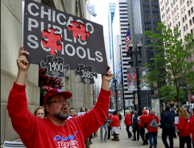 Craig Cleve marches with members of the Chicago Teachers Union as they picket outside City Hall on July 2, 2015. Christian K. Lee/AP