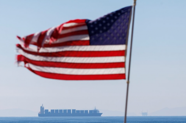 A cargo ship sits off the coast of Huntington Beach waiting for access to the Ports of Los Angeles and Long Beach in Huntington Beach, California, U.S., January 3, 2022. REUTERS/Mike Blake Purchase Licensing Rights