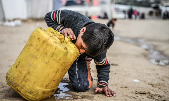 A child drinks from a plastic container in Gaza. More than 2 billion people lack access to safe drinking water. Photograph: Abed Zagout/Anadolu via Getty Images