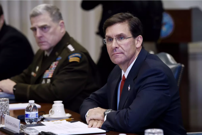 Mark Esper, right, who was secretary of defense in the first Trump administration, said the president was upset by Black Lives Matter protests in 2020 and asked Mark Milley, left, the chairman of the Joint Chiefs, “Can’t you just shoot them, just shoot them in the legs or something?” (Oiliver Douliery / AFP via Getty Images)