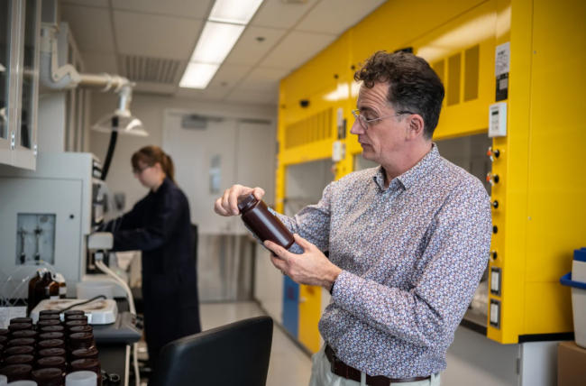 Dr. Sébastien Sauvé, University of Montreal professor of environmental chemistry, with one of his collection bottles. Photo by: Bastien Doudaine