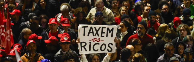 People attend a demonstration in support of taxing the super-rich in São Paulo, Brazil on July 10, 2025. (Photo by Miguel Schincariol/AFP via Getty Images)