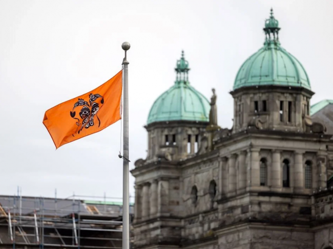 In BC, a political staffer was fired for saying that flying the orange Survivors’ flag at the legislature was a disgrace. Photo via BC government.