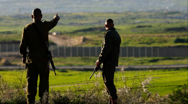 Israeli soldiers are seen looking toward Gaza this month. A internal report obtained by CBC News shows the Crown corporation in charge of international arms transfers in Canada has looked into whether shipments destined for the U.S. were potentially being used by Israel. (Amir Cohen/Reuters)