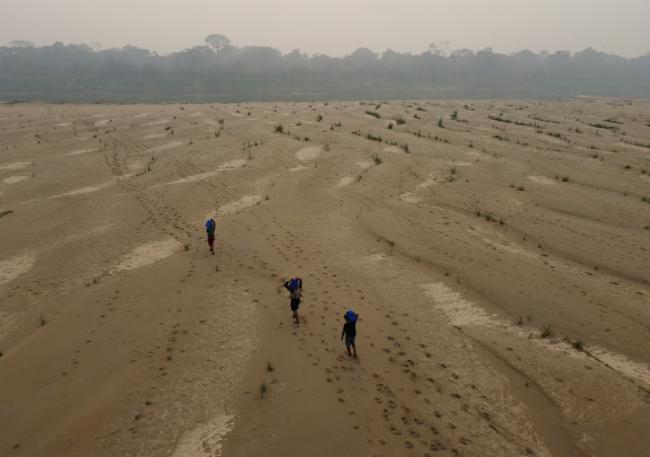 Residents transport drinking water from Humaita to the Paraizinho community, along the dry Madeira River, a tributary of the Amazon River, during the dry season, Amazonas state, Brazil, in September, 2024. Edmar Barros/The Associated Press