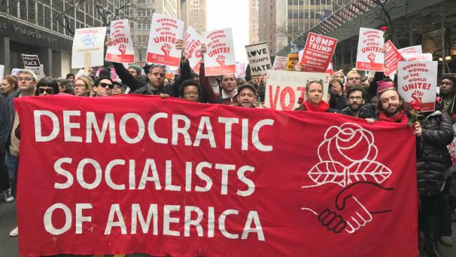 Democratic Socialists of America marching with banner