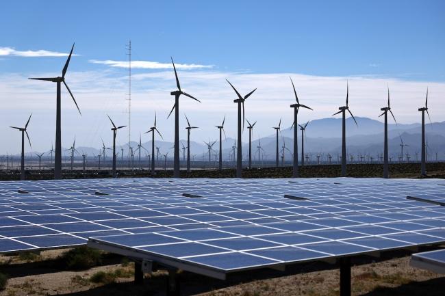 Wind turbines at a wind farm near solar panels near Palm Springs, California on March 6, 2024. Mario Tama / Getty Images