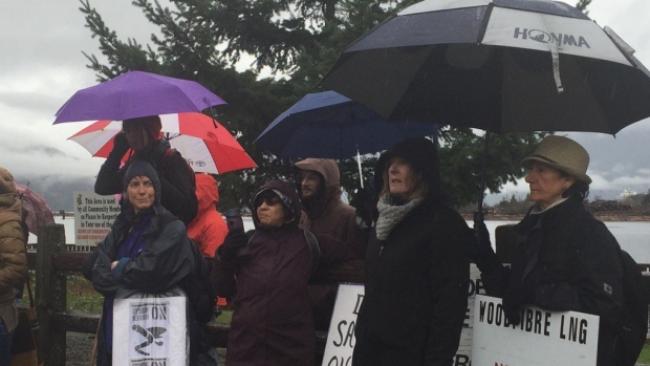 Protesters gathered in the rain in Squamish, B.C., Sunday to protest the planned Woodfibre LNG project. (Deborah Goble/CBC)