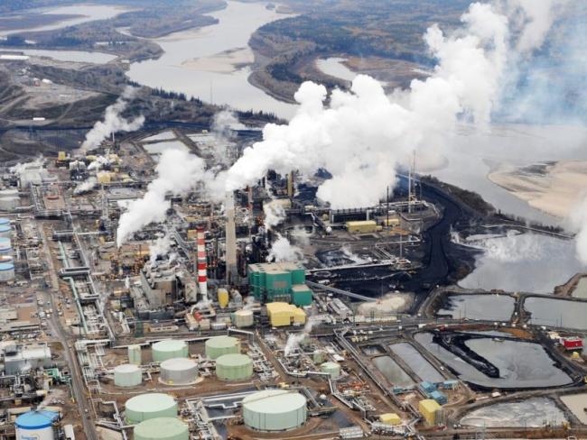 Aerial view of the Suncor oil sands extraction facility near the town of Fort McMurray. Some governments are proposing to ask oil companies to pay them for the cost of climate change damage caused by their products.	