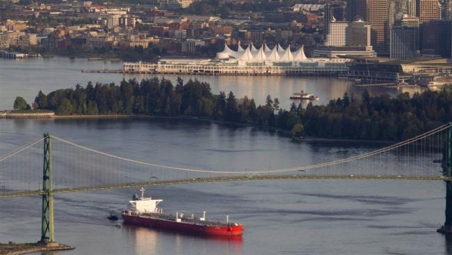 An oil tanker leaves Vancouver Harbour under the Lion's Gate bridge. File photo by Jonathan Hayward, Canadian Press