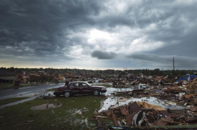 The clouds of a thunderstorm roll over neighborhoods heavily damaged in a tornado in Moore, Okla., May 23, 2013. (Credit: Reuters/Lucas Jackson)