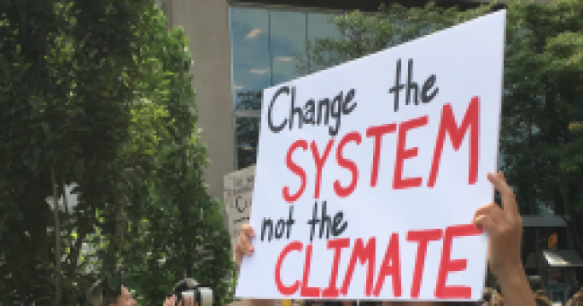 Change the system not the climate - sign