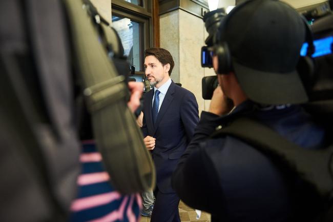 Prime Minister Justin Trudeau enters the House of Commons from a hallway in West Block on Feb. 18, 2020. Photo by Kamara Morozuk