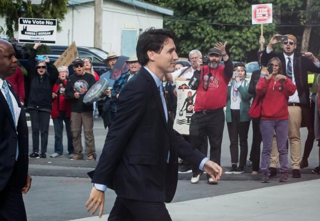 Protesters opposed to the Kinder Morgan Trans Mountain pipeline expansion shout at Prime Minister Justin Trudeau as he arrives for a discussion with the Indigenous Advisory and Monitoring Committee, on the Cheam First Nation near Chilliwack, B.C., on Tuesday.  (DARRYL DYCK / THE CANADIAN PRESS)