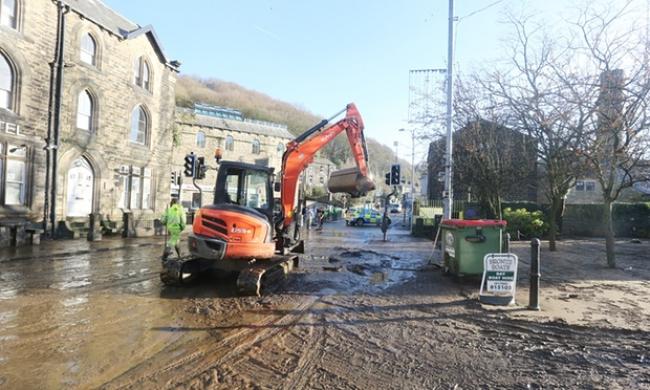 The clean up process begins in Hebden Bridge, West Yorkshire. Photograph: Barbara Cook/Demotix/Corbis