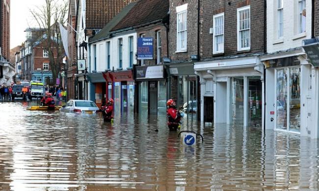 Rescue workers in York, where 3,500 homes remained at risk of flooding on Sunday. Photograph: Anna Gowthorpe/PA