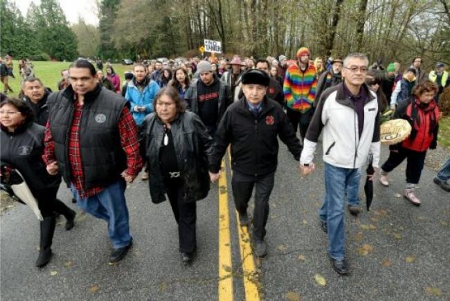 JENNIFER GAUTHIER/METRO FILE  Grand Chief Stewart Phillip, the head of the Union of B.C. Indian Chiefs, led protesters down a muddy trail deep into the conservation area’s forest on Nov. 27, 2014, where Kinder Morgan continued work at a second injunction-protected site. Phillip, his mother and several others then crossed the police tape into the work area and were arrested by RCMP, joining more than 100 others who have been willingly arrested since police began enforcing the injunction.