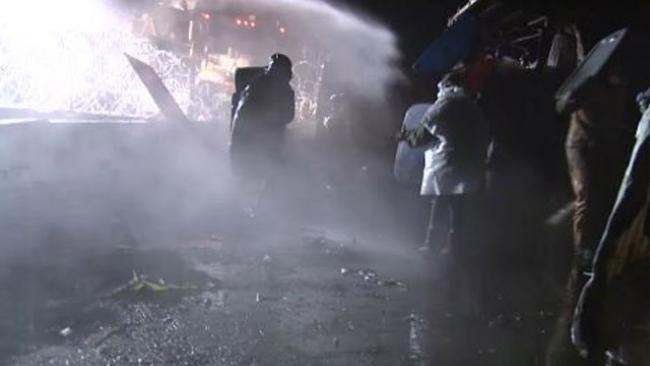 (Police would blast #NoDAPL supporters with water and then arc tear gas behind them on the bridge, trapping them. Photo: Jorge Barrera/APTN) 