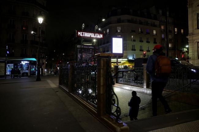 People walk outside a metro station operated by the Paris transport network RATP on the eve of a major strike by the public transport workers, in Paris, France, February 17, 2022. REUTERS/Sarah Meyssonnier