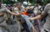 Security personnel detain a protestor during a march towards Parliament on July 20. Photo: PTI.
