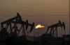 A flare burns off methane and other hydrocarbons as oil pumpjacks operate in the Permian Basin in Midland, Texas, on Tuesday, Oct. 12, 2021. File photo by The Associated Press/David Goldman