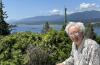 David Huntley on his home patio overlooking Burrard Inlet, where Aframax tankers pass by almost every day to load up on bitumen from the Trans Mountain pipeline's terminus at Westridge Marine Terminal, just out of sight below the treeline. Photo by Arno Kopecky/Canada's National Observer