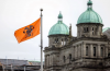 In BC, a political staffer was fired for saying that flying the orange Survivors’ flag at the legislature was a disgrace. Photo via BC government.