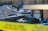 Police seen at Tumbler Ridge Secondary School Wednesday morning following a mass shooting. After police identified the suspect as a transgender teen, trans advocates say some have used the shooting as an excuse to spread hate against their community online. (Jesse Boily/The Canadian Press)