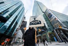 An activist hold up a placard saying, "We Are Here to Protect, Water is Life" during the demonstration. Protesters gather in solidarity with Wetísuwetíen Land Defenders in Toronto, Canada, on December 21, 2021. KATHERINE CHENG / SOPA IMAGES/LIGHTROCKET VIA GETTY IMAGES