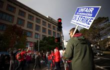 A union worker holds a strike sign as he pickets with nurses outside of the Kaiser Permanente San Francisco Medical Center on November 10, 2021, in San Francisco, California. JUSTIN SULLIVAN / GETTY IMAGES