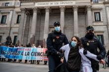 Police officers remove a climate activist of the Scientist Rebellion group from a protest in front of the Congress of Deputies in Madrid, Spain, on April 6, 2022. MARCOS DEL MAZO / LIGHTROCKET VIA GETTY IMAGES