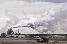 By betting it can solve its emissions problem with carbon capture and storage technology, Canada's oil and gas industry risks sadding itself with expensive stranded assets, a new report argues. A dump truck works near the Syncrude oil sands extraction facility near the city of Fort McMurray, Alberta on Sunday June 1, 2014. THE CANADIAN PRESS/Jason Franson