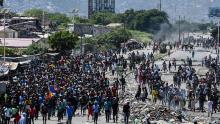 People march in Cite Soleil area of Port-au-Prince, Haiti during a protest to demand the resignation of President Jovenel Moise [Chandan Khanna/AFP]