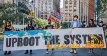 Participants seen holding a banner at the protest in New York City on September 24, 2021. Youth in New York City and across the globe led strikes as part of climate week, demanding urgent action on the climate crisis and calling on us all to #UprootTheSystem which has allowed imperialism, colonialism, racism and other systemic injustices to harm people around the world and dangerously warm the planet. (Photo: Erik McGregor/LightRocket via Getty Images)