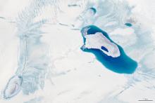 Meltwater ponds atop the ice in northwest Greenland on July 30 near the edge of the ice sheet. While summer melt along the periphery of the ice sheet is typical, melting that day covered a much higher area than usual because of a heat wave. Credit: NASA