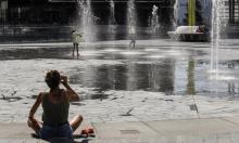 A woman drinks as children cool off in a public fountain in Milan, Italy, on 31 July. 2020 is set to be hottest or second hottest on record, in line with the longer-term trend of rising temperatures. Photograph: Luca Bruno/AP