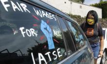 Crystal Kan, a storyboard artist, draws signs on union members’ cars during a rally at the Motion Picture Editors Guild IATSE Local 700 on Sunday in Los Angeles. Photograph: Myung J Chun/Los Angeles Times/Rex/Shutterstock